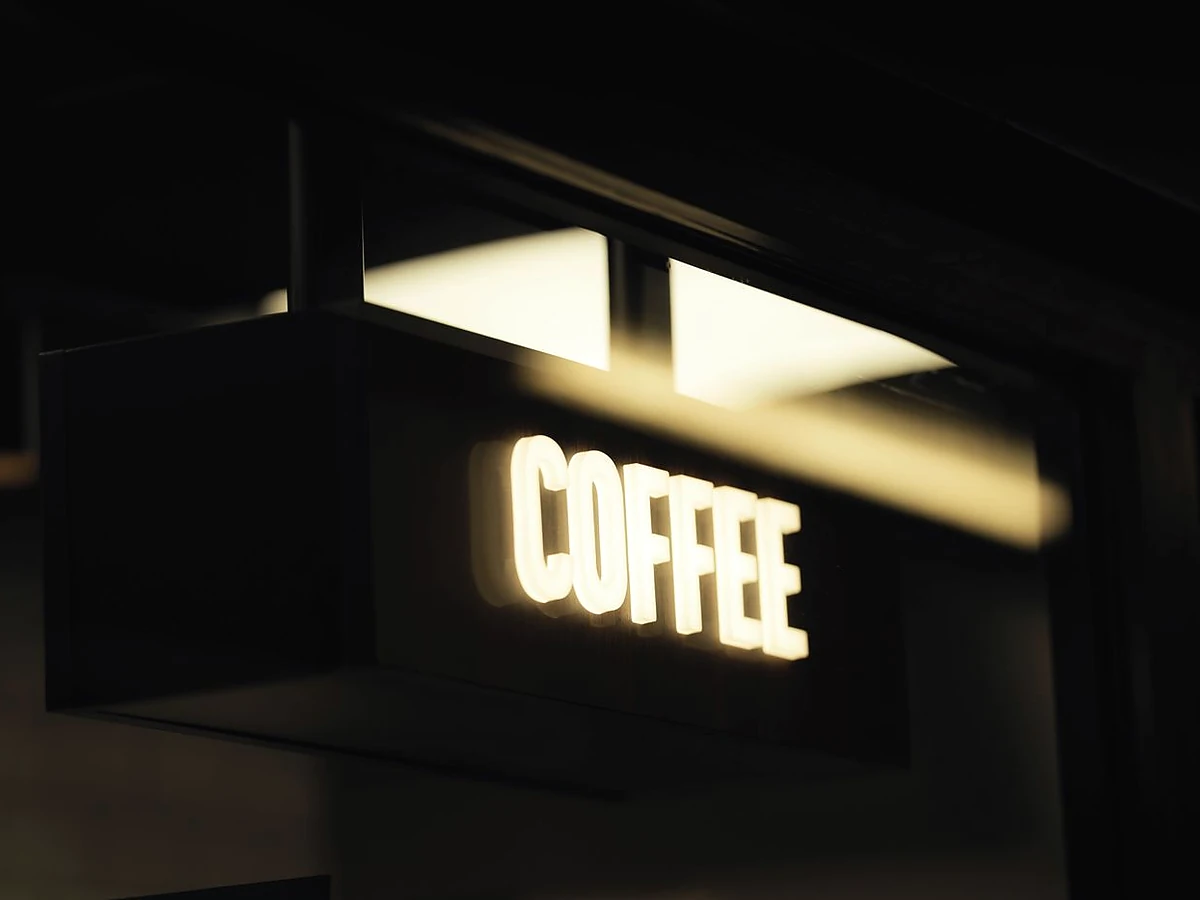 Exterior illuminated cafe light box sign at night